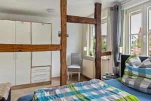 a bedroom with two bunk beds and a desk at Ferienhaus Salzwedel in Salzwedel