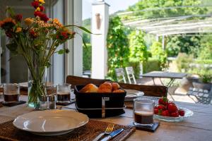 a table with a basket of bread and flowers on it at Ferienhaus Wennetraum mit Sauna in Eslohe
