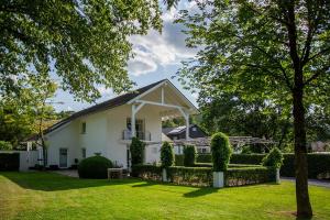 a white house with a fence and a yard at Ferienhaus Wennetraum mit Sauna in Eslohe +33 photos