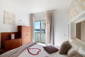 a bedroom with a bed with a heart on it at Casa Vista Mar in Albufeira