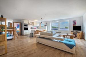a large living room with a couch and a kitchen at Ferienwohnung Knopf in Hardegsen