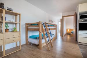 a room with two bunk beds and a kitchen at Ferienwohnung Knopf in Hardegsen