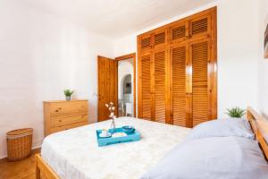 a bedroom with a bed with a blue tray on it at Vistafaro in Es Mercadal +10 photos