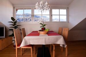 a dining room table with a bowl of fruit on it at Rosengartnerhof Apt Maultasch in Terlano +3 photos