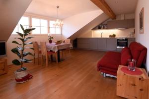 a kitchen and living room with a table and a couch at Rosengartnerhof Apt Maultasch in Terlano