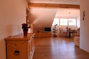 a living room with a table and a dining room at Rosengartnerhof Apt Maultasch in Terlano