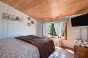 a bedroom with a bed and a flat screen tv at Las Hermanas B in Guía de Isora