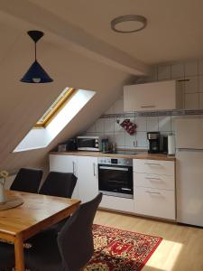 a kitchen with a wooden table and a dining room at Ferienwohnung Wolf in Nietwerder