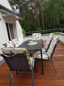 a patio table and chairs on a deck at Ferienwohnung Wolf in Nietwerder