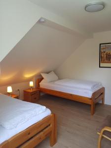 two beds in a room with two tables and two lamps at Ferienwohnung Wolf in Nietwerder