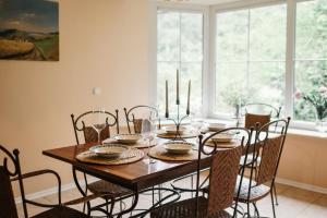 a dining room table with chairs and a dining room table at Landhaus Elbenberg in Naumburg +21 photos