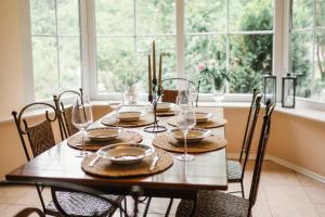 a dining room table with chairs and glasses on it at Landhaus Elbenberg in Naumburg
