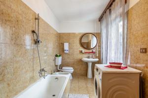 a bathroom with a tub and a toilet and a sink at Alloggio Chez Favre in Blavy +19 photos