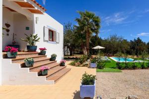 a villa with a garden and a swimming pool at Villa Prats Ibiza in Sant Josep
