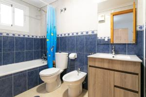 a bathroom with a toilet and a sink at Bungalow 145 in Santa Pola +16 photos