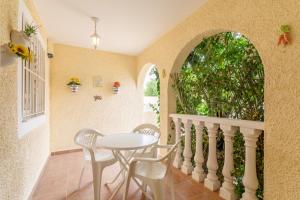 a dining room with a table and chairs and a window at Bungalow 145 in Santa Pola