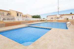 a large swimming pool with blue water at Bungalow 145 in Santa Pola