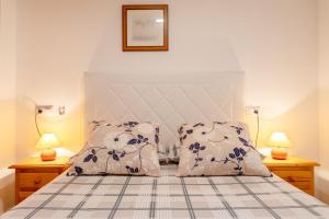 a bedroom with a bed with two pillows at Bungalow 145 in Santa Pola