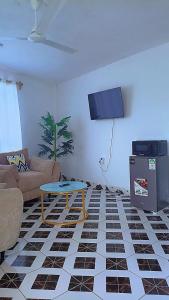 a living room with a couch and a table at Reign homes in Watamu