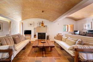 a living room with couches and a coffee table at Sa Paret Nova in Sant Francesc Xavier