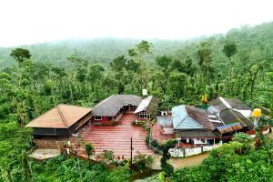 an aerial view of a house in the forest at Coffee Crown Homestay - 1km to Falls, Estate, Home Food in Sakleshpur