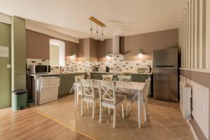 a kitchen with a table and chairs in it at La Pause Picarde - Baie De Somme 1 in Franleu +23 photos
