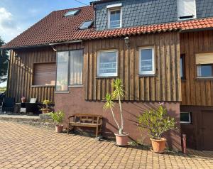 a house with a bench in front of it at Zimmer Edith in Gersfeld
