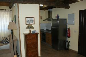 a kitchen with a stainless steel refrigerator and a counter at O Bolaño Apt 2 in Villarino de Conso