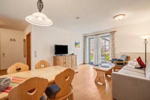 a living room with a table and a couch at Fewo Brünnstein - Nr 11 Pool, Sauna in Oberaudorf
