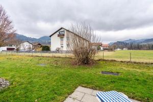 a building in a field next to a grass field at Fewo Brünnstein - Nr 11 Pool, Sauna in Oberaudorf