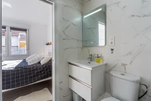 a bathroom with a toilet and a sink and a mirror at Loft A'ca La Puri en Melegís in Melegis