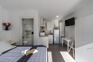 a bedroom with a bed with a book on it at Loft A'ca La Puri en Melegís in Melegis +17 photos