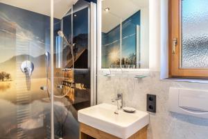 a bathroom with a sink and a shower at Ferienwohnungen Arnspitz in Krün in Krün +79 photos