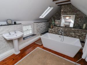a bathroom with a sink and a bath tub at The Secret Garden in Narberth +71 photos