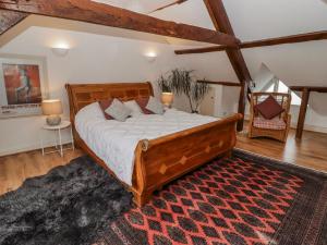 a bedroom with a large wooden bed in a room at The Secret Garden in Narberth