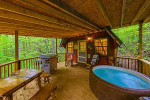a large hot tub on a deck of a cabin at Hilltop Loft in Helen