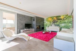 a living room with a fireplace and a red rug at Mediterranean Beach in Arenales del Sol