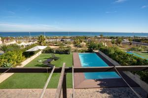 an aerial view of a resort with a swimming pool and the ocean at Mediterranean Beach in Arenales del Sol