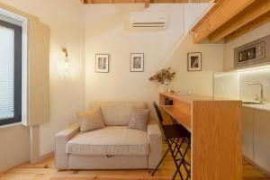 a living room with a chair and a desk at Orange Apartments B in Porto