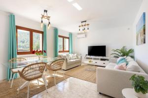 a living room with a couch and a table at Villa Prats Ibiza in Sant Josep
