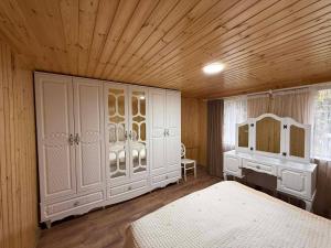 a bedroom with a bed and a dresser and a desk at Ortabatumis house in Ch'aisubani