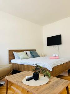a room with two beds and a coffee table at Apartment Oak Root in Mostar