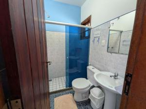 a bathroom with a toilet and a sink at Pousada Manacá — Beachfront Guesthouse on Ilha Grande in Abraão