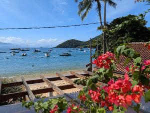 a view of a beach with boats in the water at Pousada Manacá — Beachfront Guesthouse on Ilha Grande in Abraão +33 photos