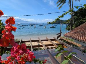 a view of a beach with boats in the water at Pousada Manacá — Beachfront Guesthouse on Ilha Grande in Abraão