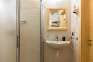 a bathroom with a sink and a shower at Appartamento Adamello 12 in Pinzolo +32 photos
