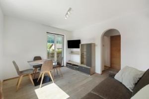 a living room with a couch and a table at Premium App Hofer Elisabeth in Villabassa