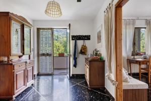 a kitchen with a door open to a dining room at Alta Via Ligure - La Squazza in Bertigaro