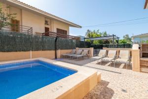 a swimming pool in the backyard of a house at Villa Gaviota in Muro