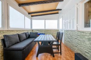 a living room with a couch and a table at Villa Gaviota in Muro